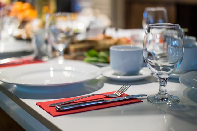 a%20table%20set%20with%20dishes%20and%20glasses%20in%20a%20restaurant a%20table%20set%20with%20dishes%20and%20glasses%20in%20a%20restaurant